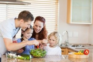 Family preparing salad together