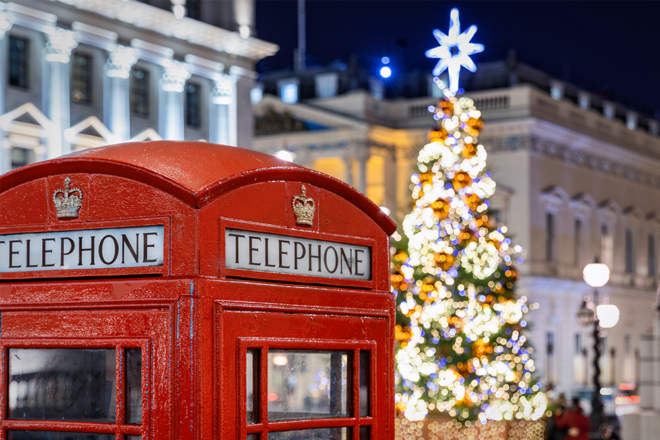 Britische Telefonzelle mit Weihnachtsbaum im Hintergrund